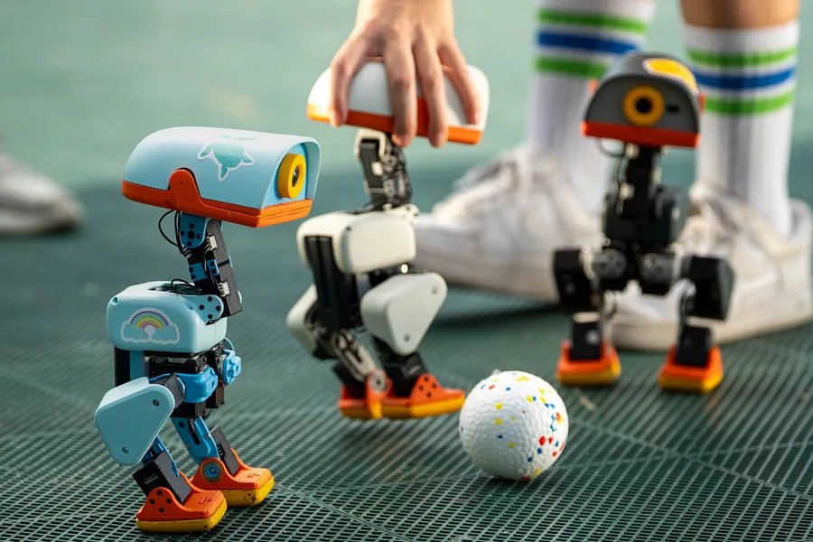 Several Microduck robot ducks in different colors standing side by side